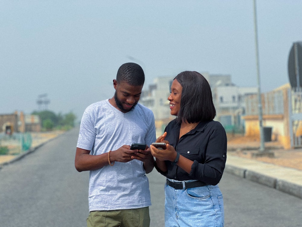 Two friends checking a payment together on their phones